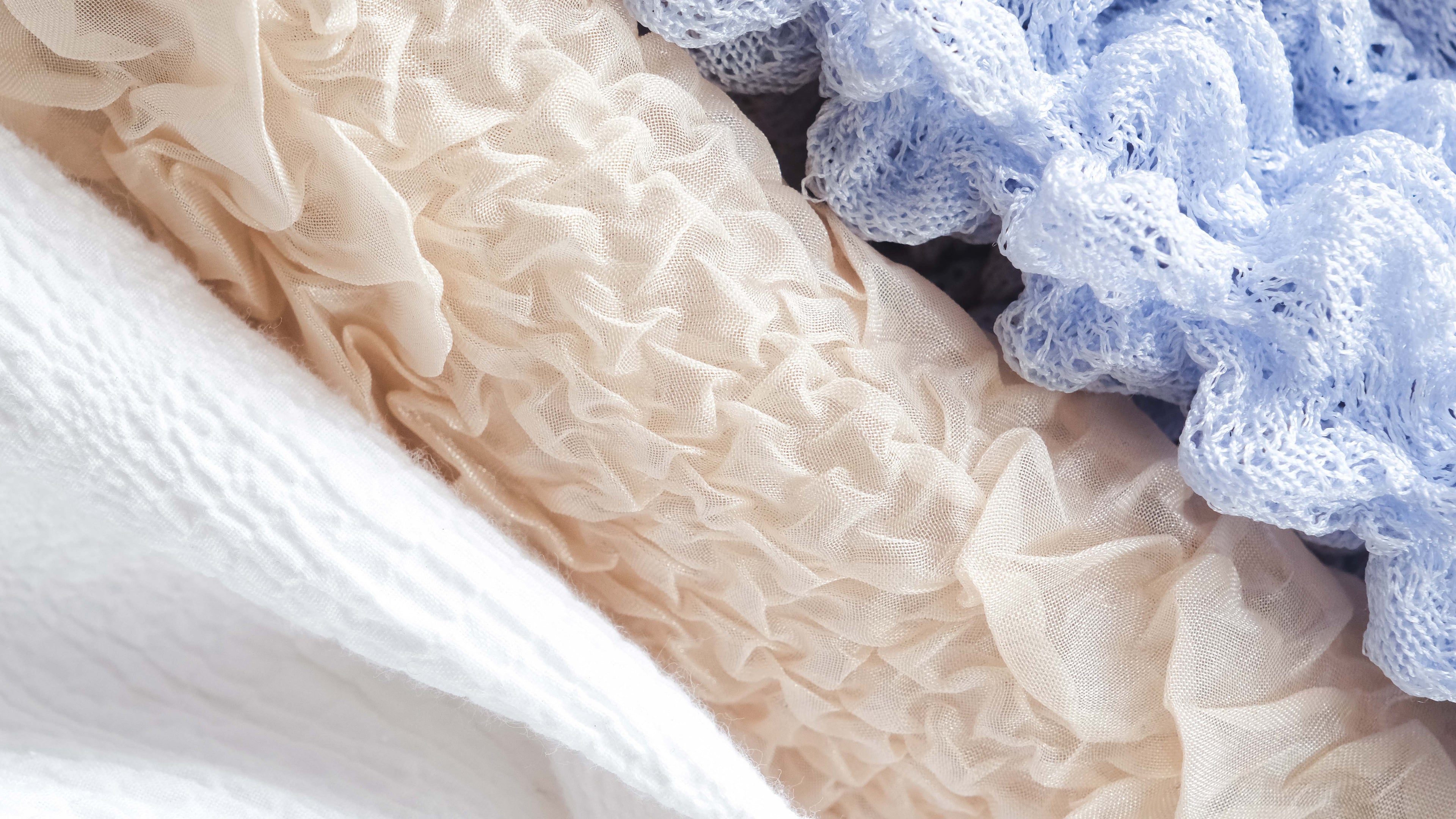 Close-up of textured fabric with a blue sponge on top